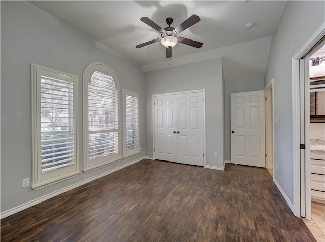 unfurnished bedroom featuring a closet, wood finished floors, a ceiling fan, and baseboards