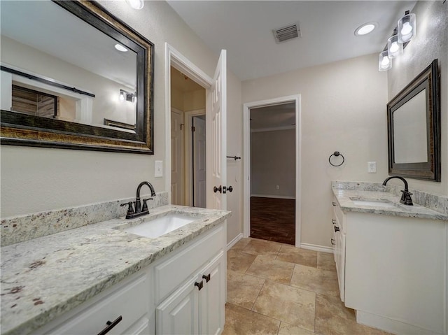 full bathroom featuring two vanities, visible vents, a sink, and baseboards