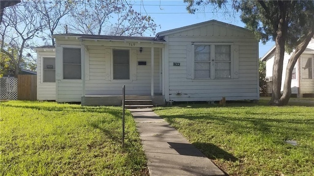 769 W Cornelia, Corpus Christi, TX 78408 - view of front of home featuring a front lawn and board and batten siding