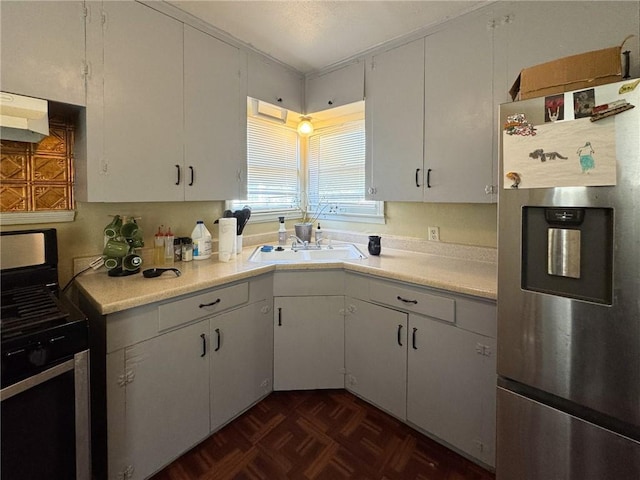 769 W Cornelia, Corpus Christi, TX 78408 - kitchen featuring appliances with stainless steel finishes, light countertops, under cabinet range hood, and white cabinetry