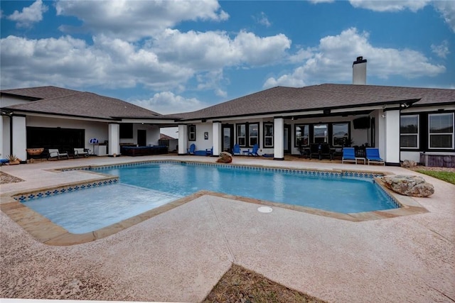 view of swimming pool with a hot tub and a patio area