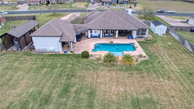 view of pool with a storage unit and a patio