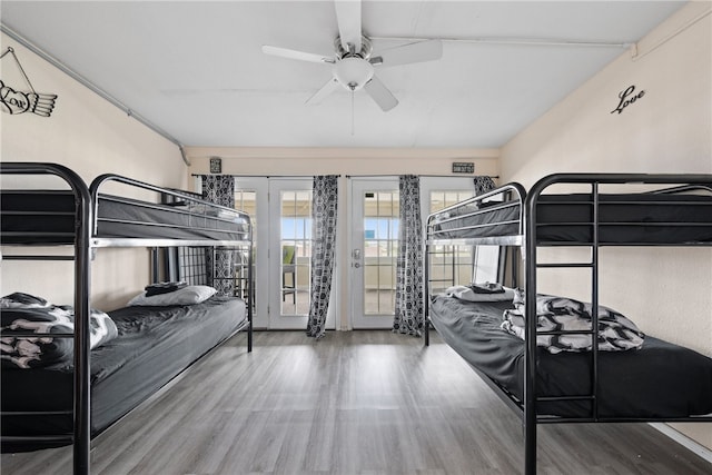 bedroom with access to exterior, ceiling fan, and wood-type flooring