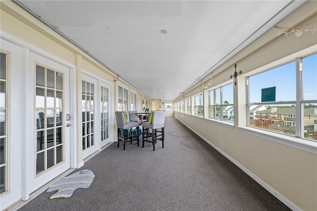 unfurnished sunroom featuring vaulted ceiling