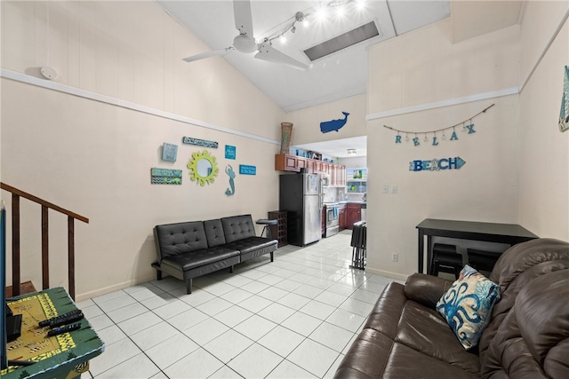 tiled living room featuring ceiling fan and lofted ceiling