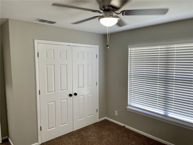 4917 Arlene Dr, Corpus Christi, TX 78411 - unfurnished bedroom with dark carpet, a closet, a ceiling fan, and baseboards