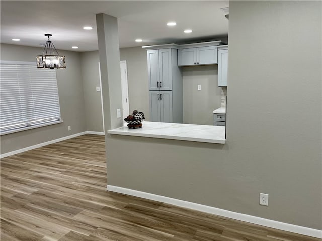 4917 Arlene Dr, Corpus Christi, TX 78411 - kitchen with recessed lighting, wood finished floors, baseboards, pendant lighting, and a chandelier