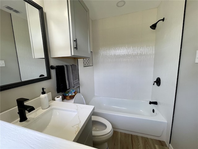 4917 Arlene Dr, Corpus Christi, TX 78411 - bathroom featuring wood finished floors, toilet, bathtub / shower combination, and vanity