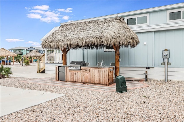 view of patio featuring an outdoor kitchen, a grill, and a gazebo