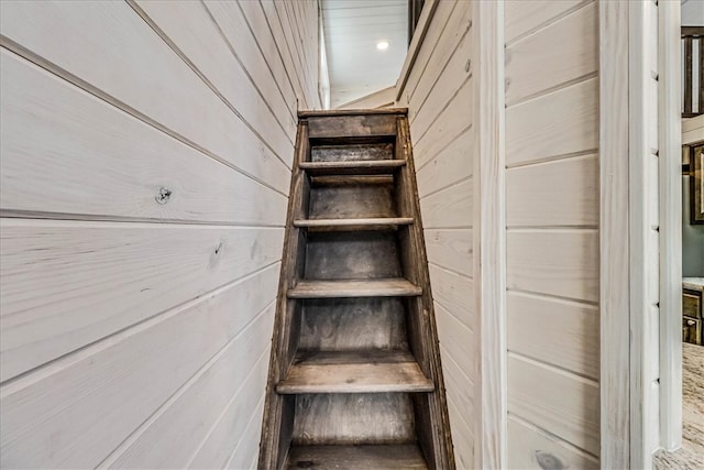 stairs with wood walls