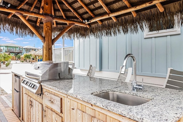 view of patio / terrace with area for grilling, sink, and a gazebo