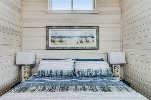 bedroom featuring wood walls