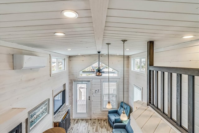 foyer entrance featuring wood walls, beamed ceiling, an AC wall unit, and light hardwood / wood-style flooring