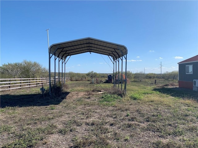 view of yard with a carport and a rural view