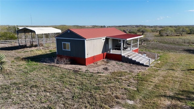 exterior space featuring a carport and a rural view