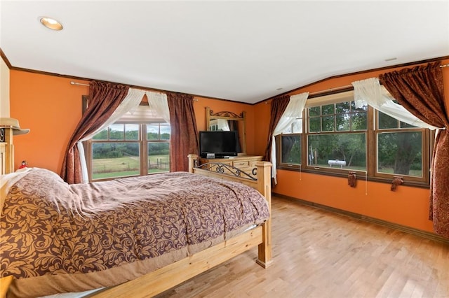 bedroom featuring light wood-type flooring and ornamental molding