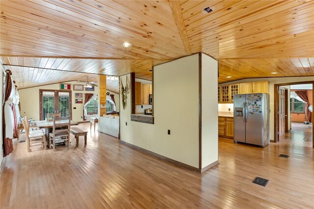 dining space with light wood-type flooring, vaulted ceiling, ceiling fan, and wooden ceiling