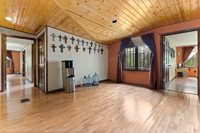 additional living space with light hardwood / wood-style floors, a healthy amount of sunlight, and wooden ceiling