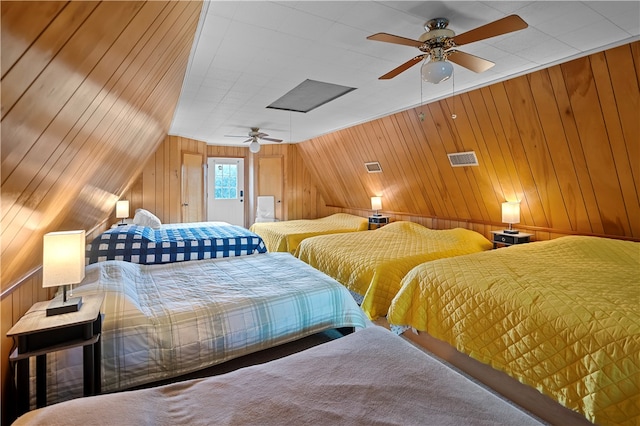 bedroom featuring wood walls and ceiling fan