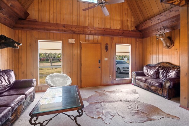 living room featuring ceiling fan, wooden walls, wood ceiling, and light colored carpet