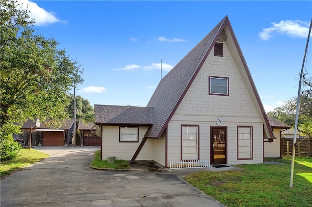 view of front of property with a garage and a front yard