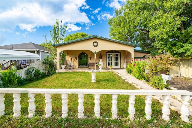 mediterranean / spanish home featuring a front yard and french doors