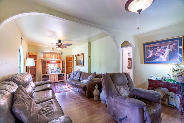 living room with wood-type flooring and ceiling fan