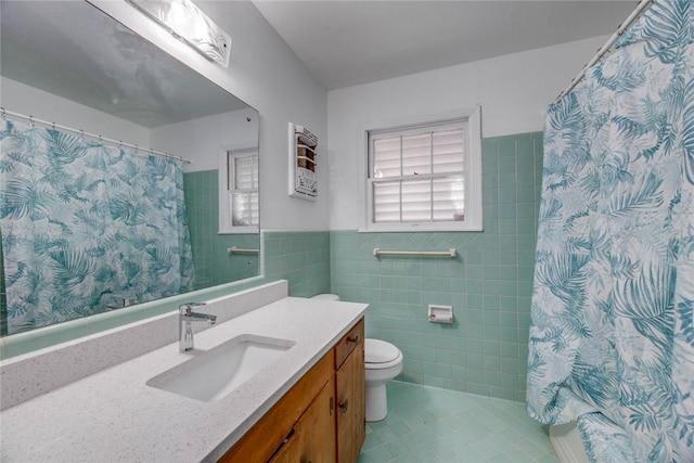 3730 Fort Worth St, Corpus Christi, TX 78411 - full bathroom with tile walls, tile patterned flooring, toilet, vanity, and a shower with curtain