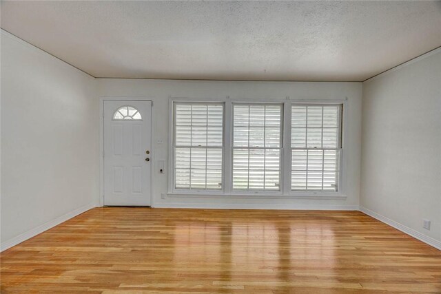 3730 Fort Worth St, Corpus Christi, TX 78411 - foyer entrance with light wood-type flooring, baseboards, and a textured ceiling