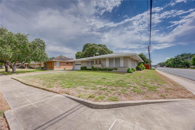 3730 Fort Worth St, Corpus Christi, TX 78411 - ranch-style home featuring an attached garage, a front lawn, concrete driveway, and brick siding