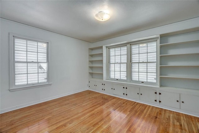 3730 Fort Worth St, Corpus Christi, TX 78411 - unfurnished room with light wood-type flooring, healthy amount of natural light, baseboards, and built in shelves