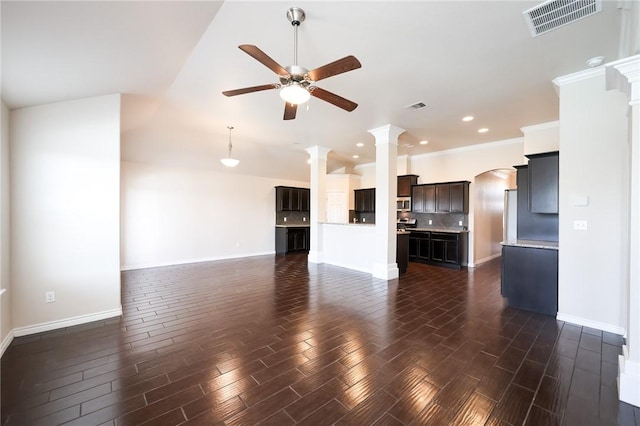 unfurnished living room featuring ornate columns, dark wood finished floors, visible vents, and a ceiling fan