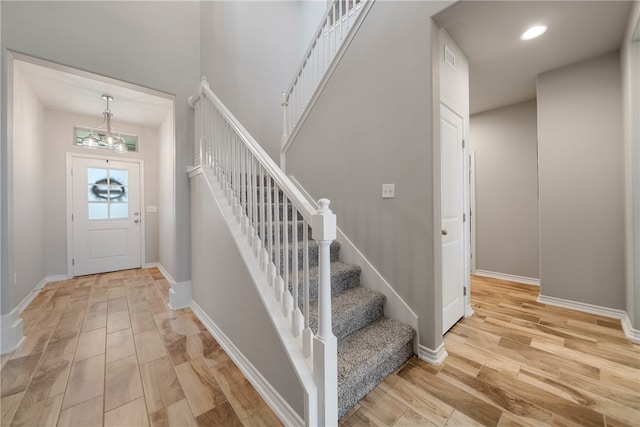 foyer with a chandelier and light wood-type flooring