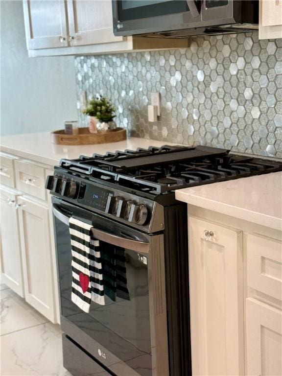 4122 Nadia Dr, Corpus Christi, TX 78414 - kitchen with white cabinetry, light countertops, appliances with stainless steel finishes, decorative backsplash, and marble finish floor