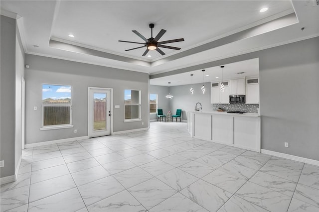 4122 Nadia Dr, Corpus Christi, TX 78414 - unfurnished living room with a tray ceiling, ceiling fan, ornamental molding, and marble finish floor