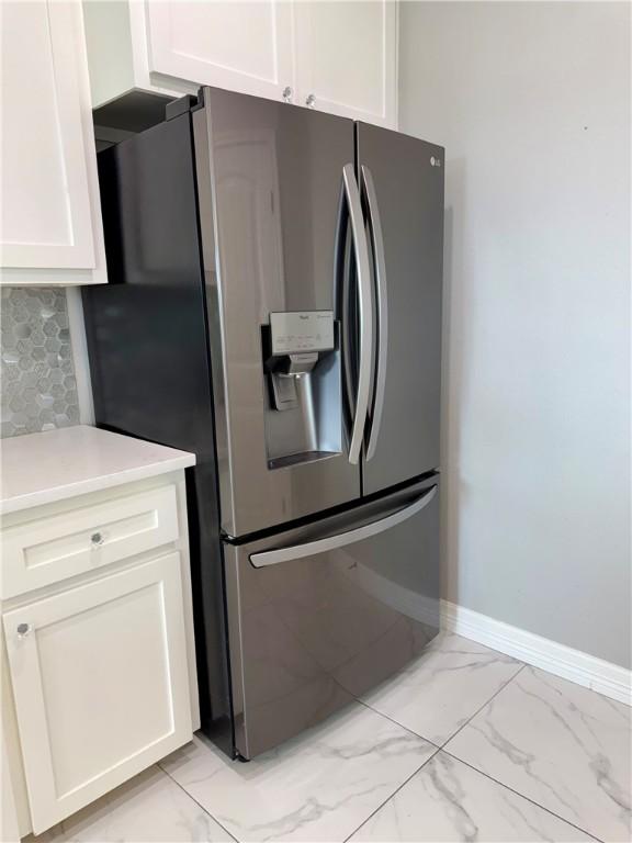 4122 Nadia Dr, Corpus Christi, TX 78414 - kitchen with white cabinetry, marble finish floor, light countertops, and stainless steel fridge with ice dispenser