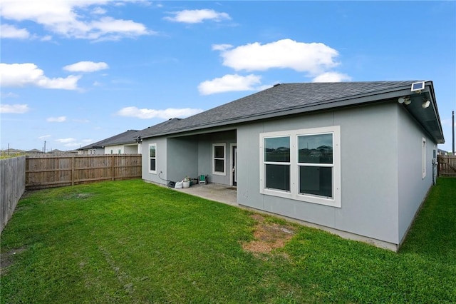 4122 Nadia Dr, Corpus Christi, TX 78414 - rear view of house featuring a shingled roof, stucco siding, a lawn, and a fenced backyard