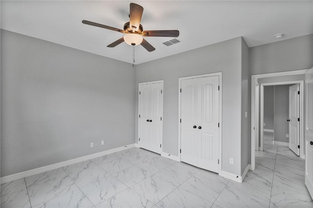 4122 Nadia Dr, Corpus Christi, TX 78414 - unfurnished bedroom with marble finish floor, multiple closets, visible vents, ceiling fan, and baseboards