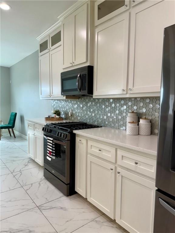 4122 Nadia Dr, Corpus Christi, TX 78414 - kitchen featuring glass insert cabinets, marble finish floor, black appliances, light countertops, and tasteful backsplash