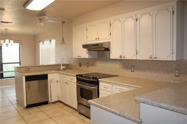 kitchen with kitchen peninsula, appliances with stainless steel finishes, and pendant lighting