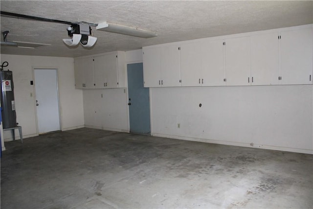 garage featuring electric water heater and a garage door opener