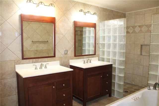 bathroom with backsplash, tile walls, shower with separate bathtub, and vanity