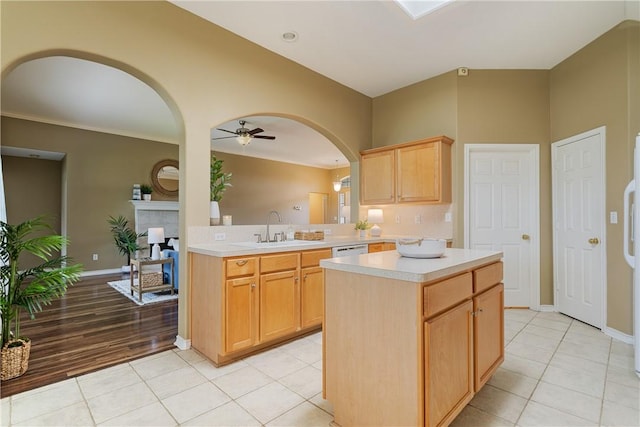 5909 Sutherland Dr, Corpus Christi, TX 78414 - kitchen with arched walkways, light countertops, light brown cabinets, ceiling fan, and light tile patterned floors