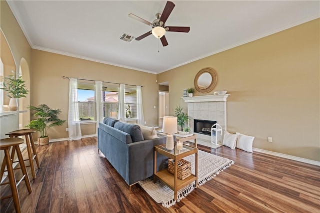 5909 Sutherland Dr, Corpus Christi, TX 78414 - living area with ceiling fan, dark wood-style floors, a tiled fireplace, and ornamental molding