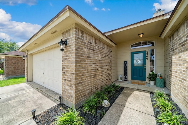 5909 Sutherland Dr, Corpus Christi, TX 78414 - property entrance with brick siding, a garage, concrete driveway, and a chimney