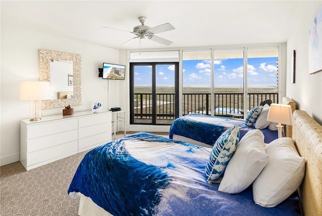 carpeted bedroom with expansive windows, ceiling fan, and access to outside