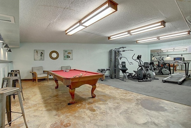 recreation room with pool table, a textured ceiling, and concrete floors