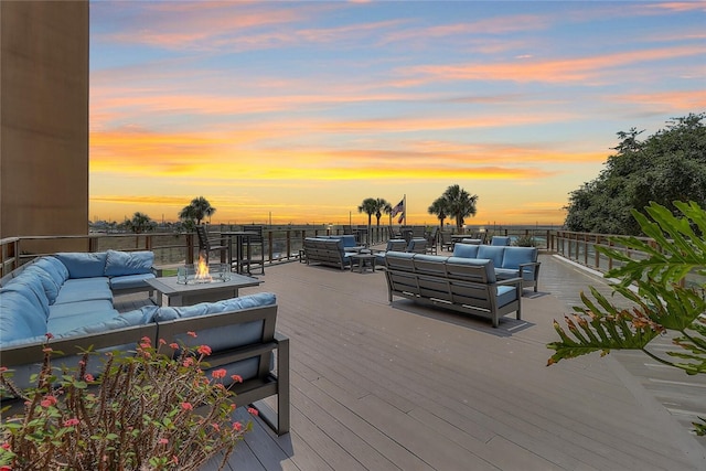 deck at dusk with an outdoor living space