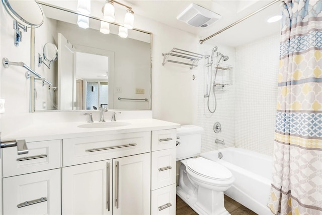 full bathroom with vanity, hardwood / wood-style flooring, toilet, and shower / tub combo