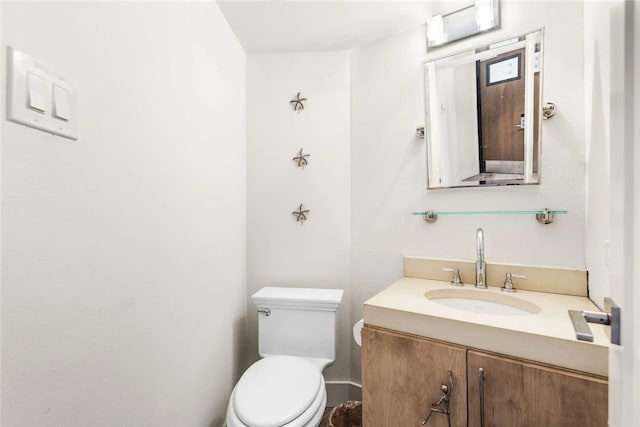 bathroom featuring toilet and vanity